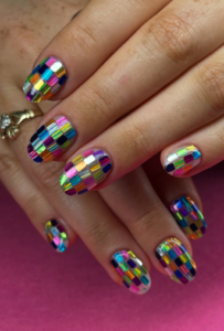 Colorful geometric party nail art with vibrant multicolor accents